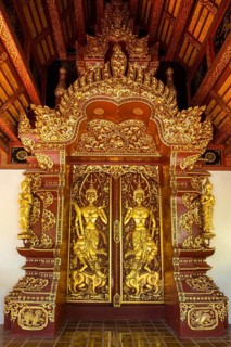 Teak entrance gate decorated with gold leaf in Wat Phrah Singh Temple