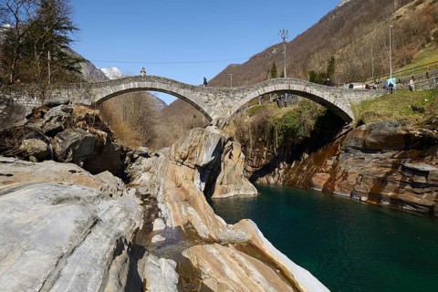Historic bridge Ponte dei Salti with double arches through the Verzasca River