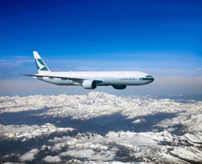 Cathay Pacific Boeing 777-367 ER in flight over mountains