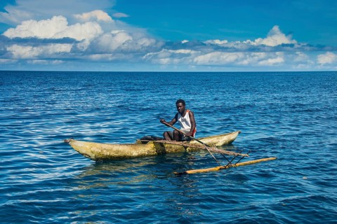 Man in an outrigger boat