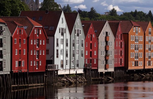 Colourful wooden houses on stilts on the Nidelv River