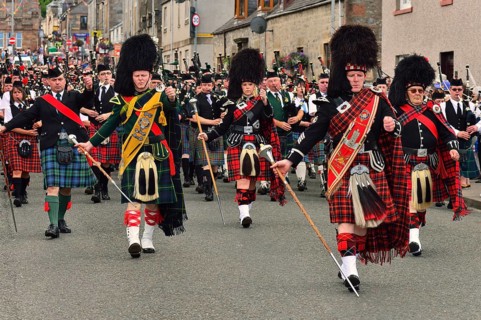 Pipe majors of various pipe bands leading the parade through the town