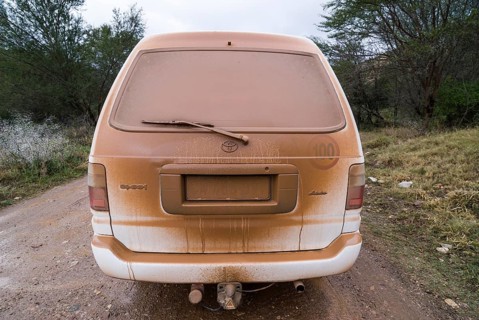 Dusty car on on a gravel road
