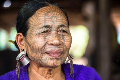 Woman with a traditional facial tattoo and ear jewelry