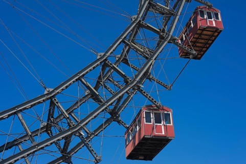 Two cabins of the Wiener Riesenrad ferris wheel against a blue sky at the Prater