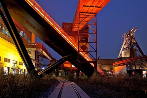 Illuminated gangway to the Ruhr Museum at the Zeche Zollverein Coal Mine Shaft XII with the headframe