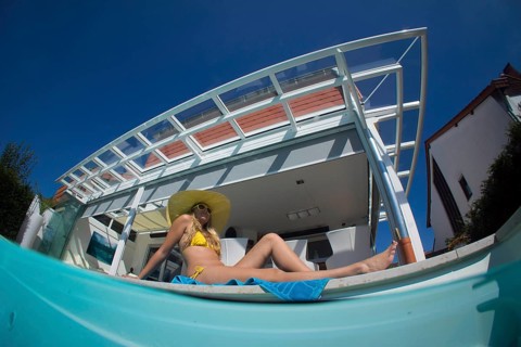 Young woman lying beside a private pool