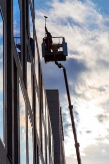 Window cleaner cleaning the windows of a hotel