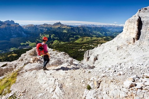 Mountain climber descending from Heiligkreuzkofel Mountain along the Heiligkreuzkofelsteig climbing route in the Fanes Group in Fanes-Sennes-Prags Nature Park