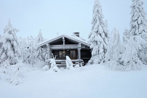 Finnish log cabin in the snow-covered landscape