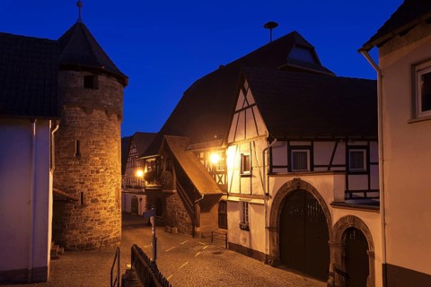 Historical Town Hall with a fortified wall and the tower of a fortified church
