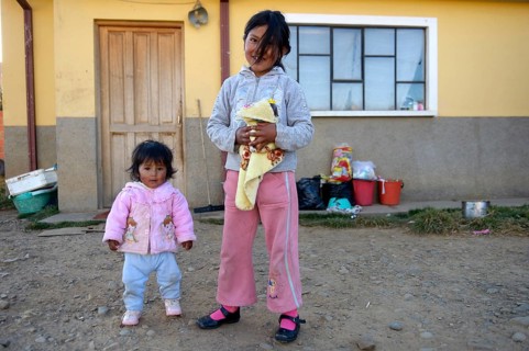 Two girls standing in front of a house