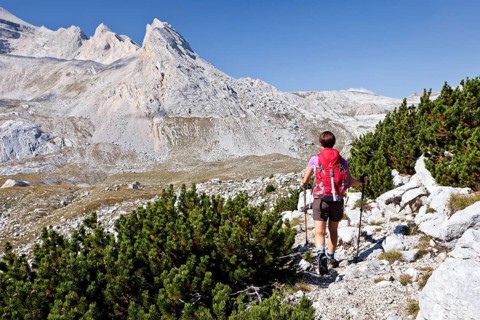 Mountain climber ascending Piz de Lavarela Mountain in the Fanes Group in Fanes-Sennes-Prags Nature Park