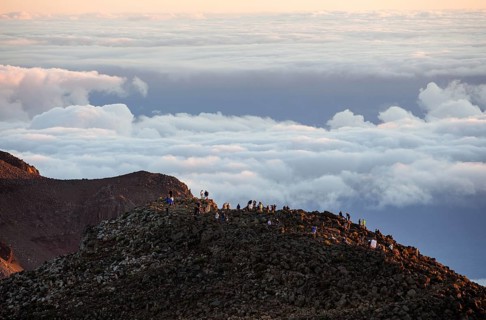 Tourists on the summit of the Haleakala volcano at sunrise