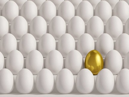 Golden egg amidst white eggs