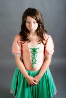 Girl wearing an old-fashioned dress looking sad