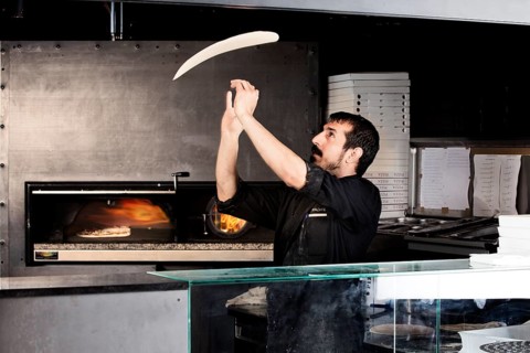 Pizza baker preparing the pizza dough