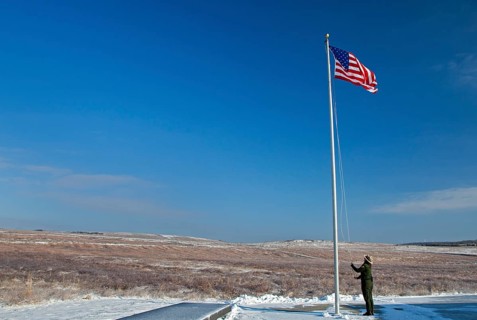 A park ranger raises the flag at the The Flight 93 National Memorial
