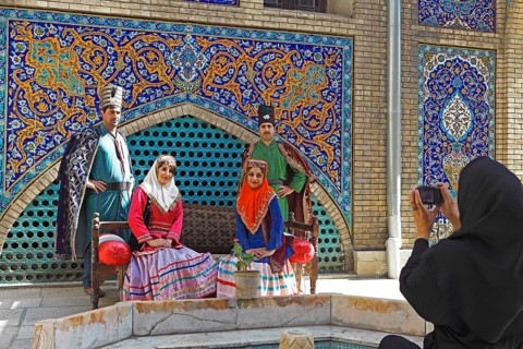 Wedding couples having their pictures taken in traditional costume