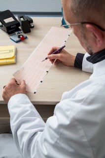 Doctor checking an ECG finding