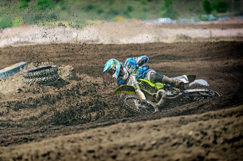 Motocross rider falling in a curve