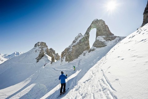 Skiers and snow-covered mountains