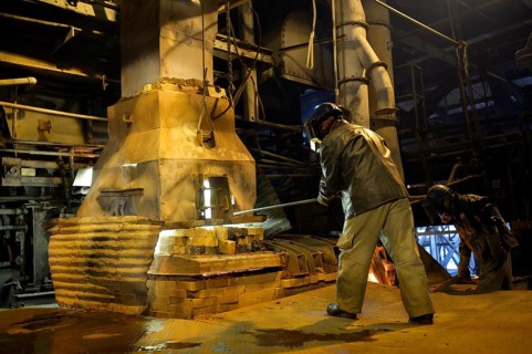 Worker working at a melting furnace in the dated and derelict Doe Run ironworks