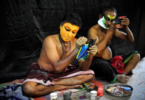 Kathakali actors applying makeup
