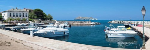 The marina of Macinaggio with the barrier island La Giraglia
