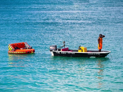 Man hiring out boats waits for customers