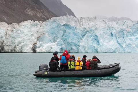 Tourists and guides in an inflatable boat