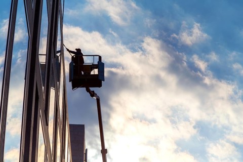 Window cleaner cleaning the windows of a hotel