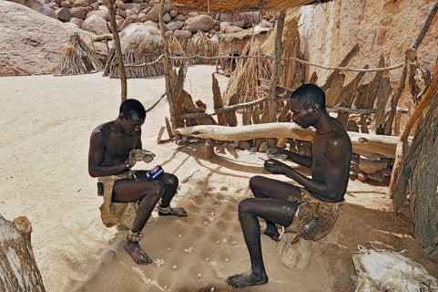 Two local men rolling cigarettes