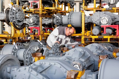 Worker checking truck drive axles from MAN Truck and Bus AG