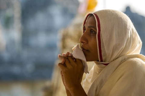 A Jain nun praying at a temple