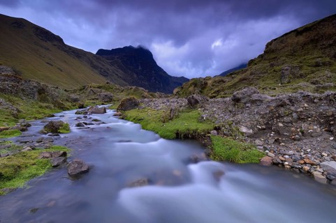 Mountain stream with the peaks of El Altar or Kapak Urku