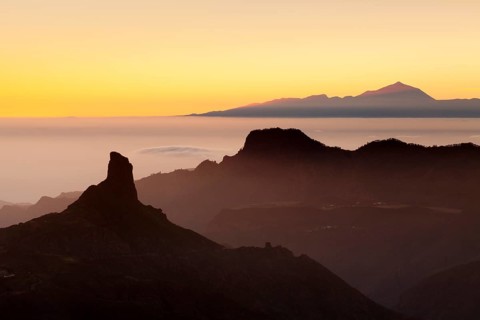 Rock formation of Roque Bentayga in front of Tenerife with Mount Teide