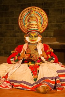Kathakali dancer in full makeup wearing a costume