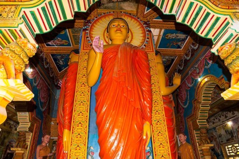 Statue in the old Buddhist temple complex of Sri Pushparama Maha Viharaya