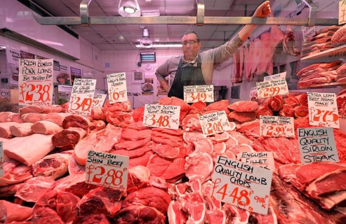Butcher behind his display