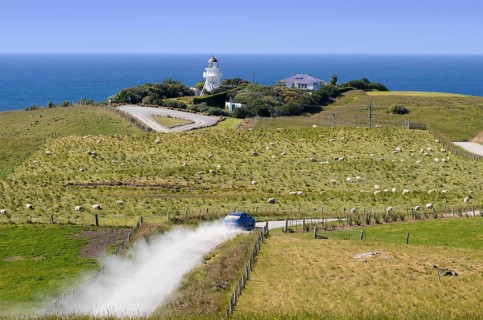 Car driving along a gravel road towards Katiki Point Lighthouse