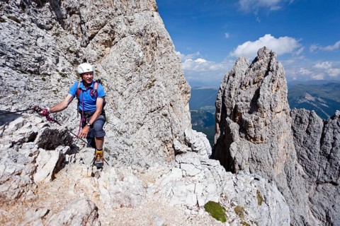 Mountain climber ascending Plattkofel mountain along the Oskar-Schuster Stieg climbing route