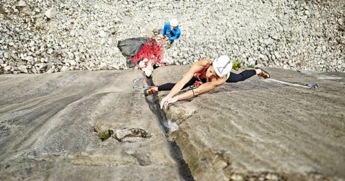 Woman lead climbing a gully