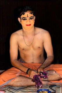 Kathakali dancer applying makeup in preparation for his performance