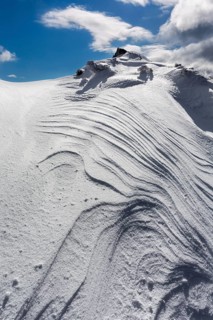 Overhanging snow with wind grooves or Sastrugi ridges