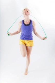 Woman in sportswear jumping rope