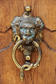 Lion head as a door knocker at the entrance portal