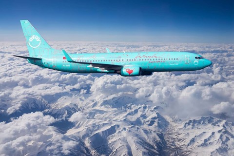 SunExpress Boeing 737 in flight over mountains