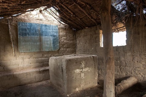 A simple earth building serves as both a school and church