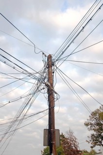 Telephone pole with tangled cables